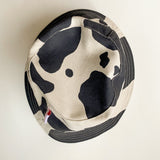 LISA SAYS GAH Britt Bucket Hat in Black/Ivory Cow Print